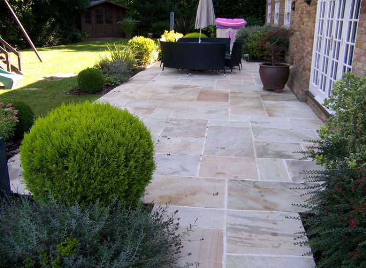 Fossil Mint Sandstone Paving in Cobham, Surrey - A rear terrace relaid using the original Fossil Mint Sandstone paving. Garden Paving - MDB Landscapes