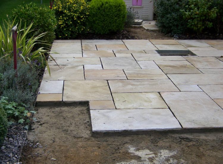 Fossil Mint Sandstone Paving in Cobham, Surrey - A rear terrace relaid using the original Fossil Mint Sandstone paving. Garden Paving - MDB Landscapes