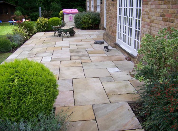 Fossil Mint Sandstone Paving in Cobham, Surrey - A rear terrace relaid using the original Fossil Mint Sandstone paving. Garden Paving - MDB Landscapes