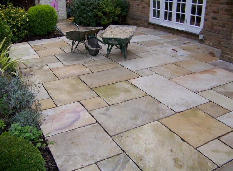 Fossil Mint Sandstone Paving in Cobham, Surrey - A rear terrace relaid using the original Fossil Mint Sandstone paving. Garden Paving - MDB Landscapes