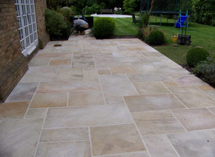Fossil Mint Sandstone Paving in Cobham, Surrey - A rear terrace relaid using the original Fossil Mint Sandstone paving. Garden Paving - MDB Landscapes
