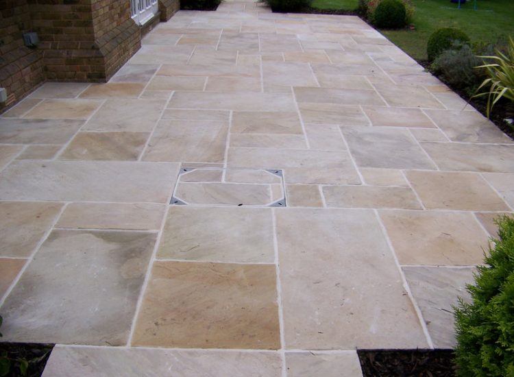 Fossil Mint Sandstone Paving in Cobham, Surrey - A rear terrace relaid using the original Fossil Mint Sandstone paving. Garden Paving - MDB Landscapes