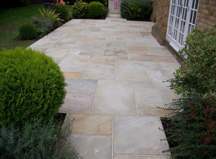 Fossil Mint Sandstone Paving in Cobham, Surrey - A rear terrace relaid using the original Fossil Mint Sandstone paving. Garden Paving - MDB Landscapes