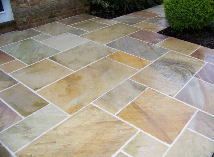 Fossil Mint Sandstone Paving in Cobham, Surrey - A rear terrace relaid using the original Fossil Mint Sandstone paving. Garden Paving - MDB Landscapes