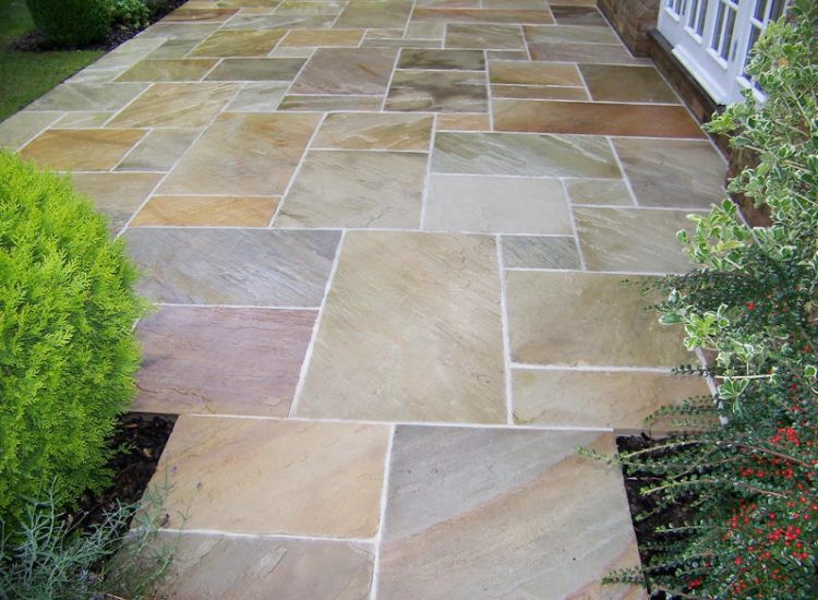 Fossil Mint Sandstone Paving in Cobham, Surrey - A rear terrace relaid using the original Fossil Mint Sandstone paving. Garden Paving - MDB Landscapes