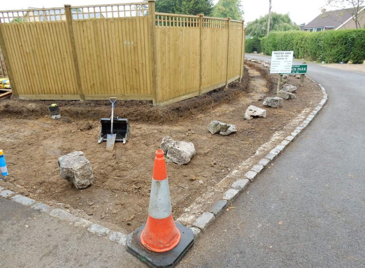 Instant Holly Hedging in Little Bookham, Surrey - Total transformation of an altered boundary line replacing rhododendrons and large conifer trees with Ilex aquifolium hedging. Garden plants and planting for Surrey and Hampshire - MDB Landscapes