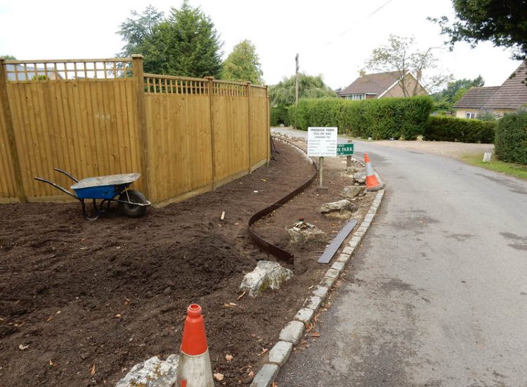 Instant Holly Hedging in Little Bookham, Surrey - Total transformation of an altered boundary line replacing rhododendrons and large conifer trees with Ilex aquifolium hedging. Garden plants and planting for Surrey and Hampshire - MDB Landscapes