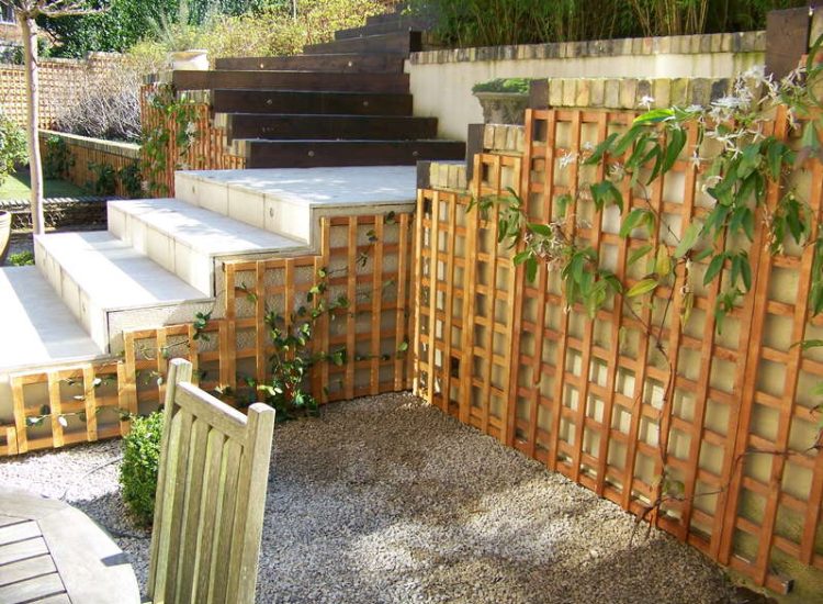 Trellis Work in Godalming, Surrey - Large surface areas of retaining wall visually altered with the use trellis panels and mirrors. Garden Fencing - MDB Landscapes