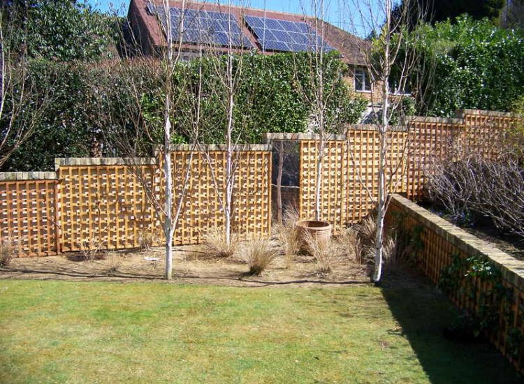Trellis Work in Godalming, Surrey - Large surface areas of retaining wall visually altered with the use trellis panels and mirrors. Garden Fencing - MDB Landscapes