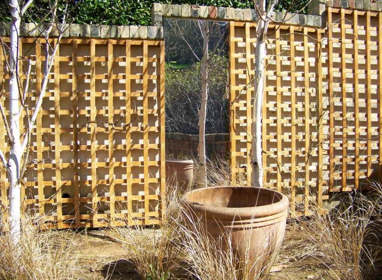 Trellis Work in Godalming, Surrey - Large surface areas of retaining wall visually altered with the use trellis panels and mirrors. Garden Fencing - MDB Landscapes