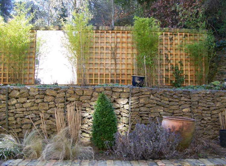 Trellis Work in Godalming, Surrey - Large surface areas of retaining wall visually altered with the use trellis panels and mirrors. Garden Fencing - MDB Landscapes