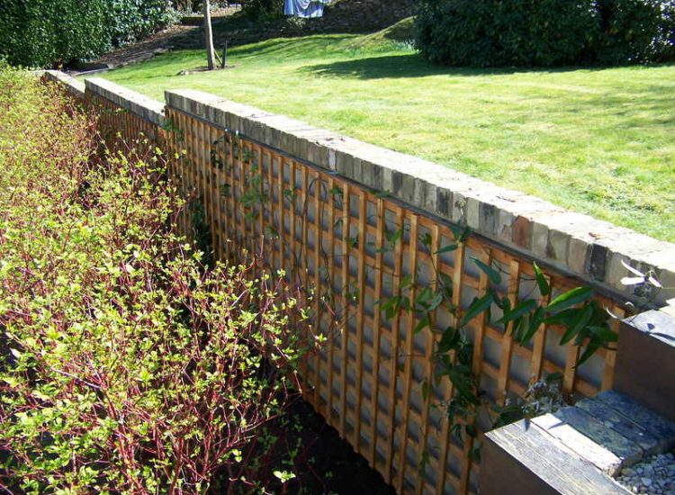 Trellis Work in Godalming, Surrey - Large surface areas of retaining wall visually altered with the use trellis panels and mirrors. Garden Fencing - MDB Landscapes
