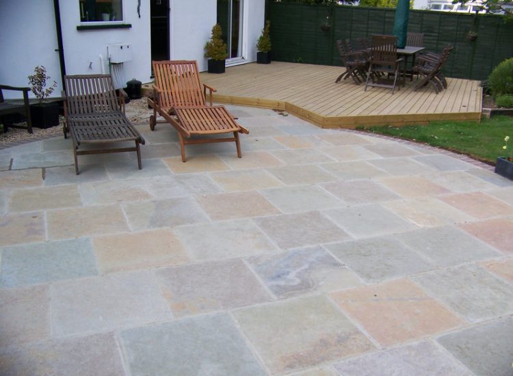 Kota Brown Limestone Paving in Fleet, Hampshire - A circular edged terrace area with adjacent timber decking. Garden Paving - MDB Landscapes