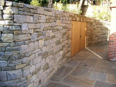 Cropped and Split Faced Stone Walling in Bramley, Surrey - Stone walling facing reinforced blockwork retaining walls. Garden Walling - MDB Landscapes