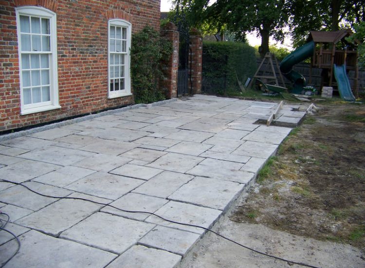 Reclaimed Yorkstone Paving in Dippenhall, Farnham, Surrey - A large rear terrace relaid using traditional reclaimed English Yorkstone. Garden Paving - MDB Landscapes