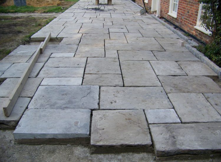 Reclaimed Yorkstone Paving in Dippenhall, Farnham, Surrey - A large rear terrace relaid using traditional reclaimed English Yorkstone. Garden Paving - MDB Landscapes