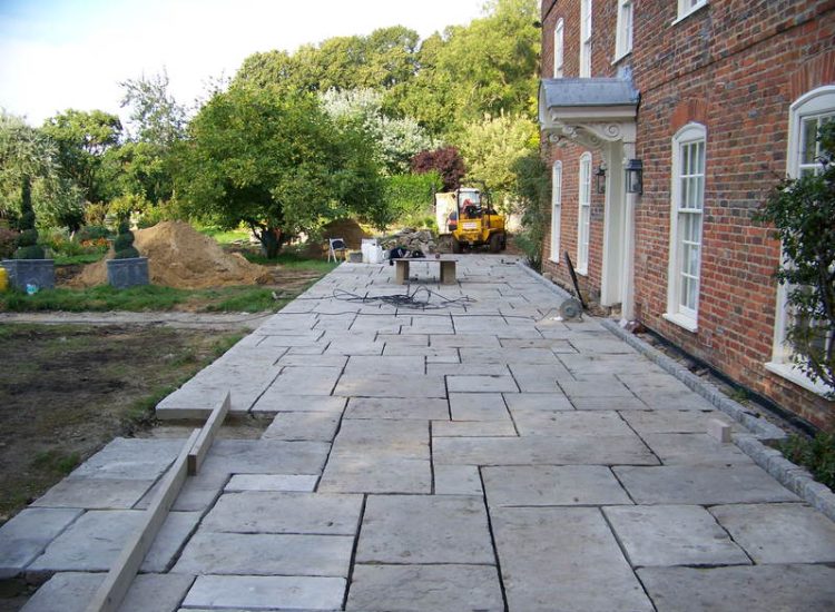 Reclaimed Yorkstone Paving in Dippenhall, Farnham, Surrey - A large rear terrace relaid using traditional reclaimed English Yorkstone. Garden Paving - MDB Landscapes