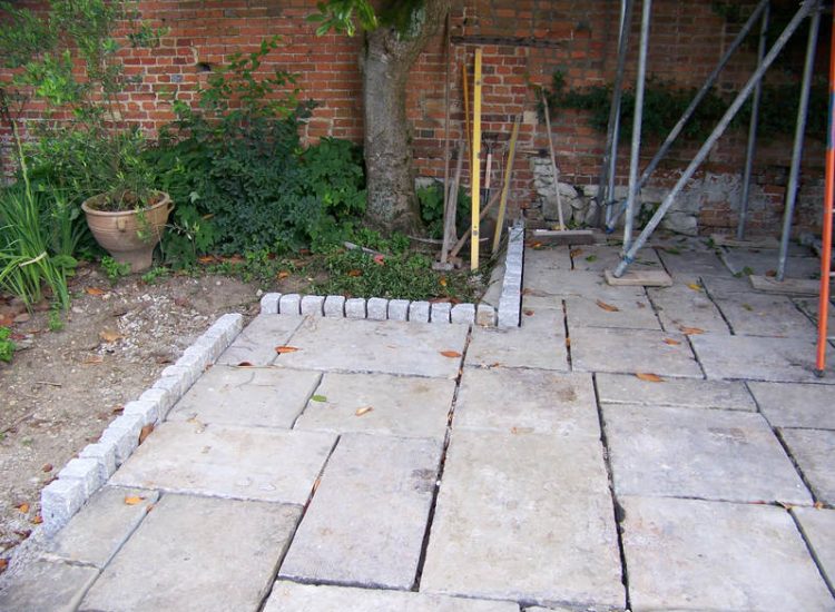 Reclaimed Yorkstone Paving in Dippenhall, Farnham, Surrey - A large rear terrace relaid using traditional reclaimed English Yorkstone. Garden Paving - MDB Landscapes