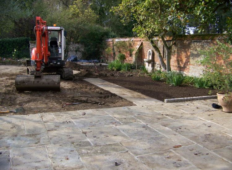 Reclaimed Yorkstone Paving in Dippenhall, Farnham, Surrey - A large rear terrace relaid using traditional reclaimed English Yorkstone. Garden Paving - MDB Landscapes