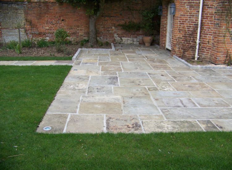 Reclaimed Yorkstone Paving in Dippenhall, Farnham, Surrey - A large rear terrace relaid using traditional reclaimed English Yorkstone. Garden Paving - MDB Landscapes