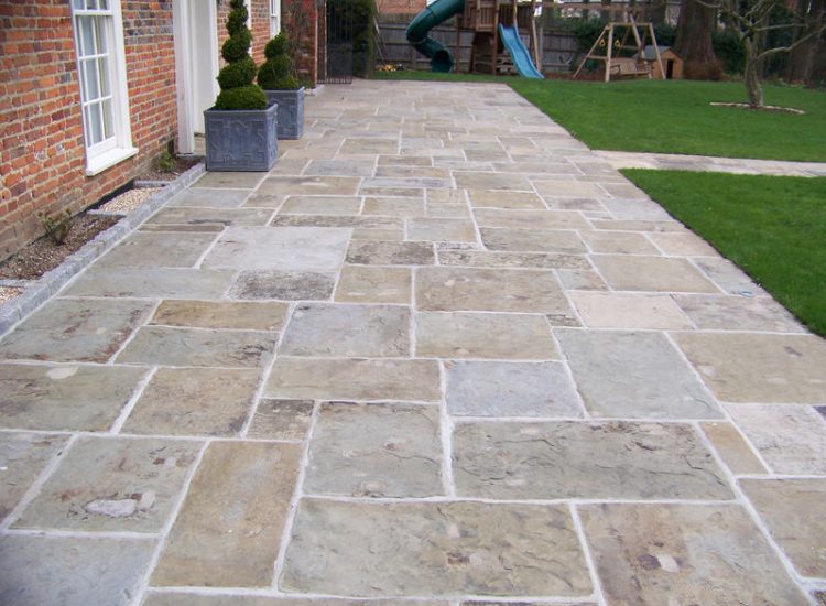 Reclaimed Yorkstone Paving in Dippenhall, Farnham, Surrey - A large rear terrace relaid using traditional reclaimed English Yorkstone. Garden Paving - MDB Landscapes
