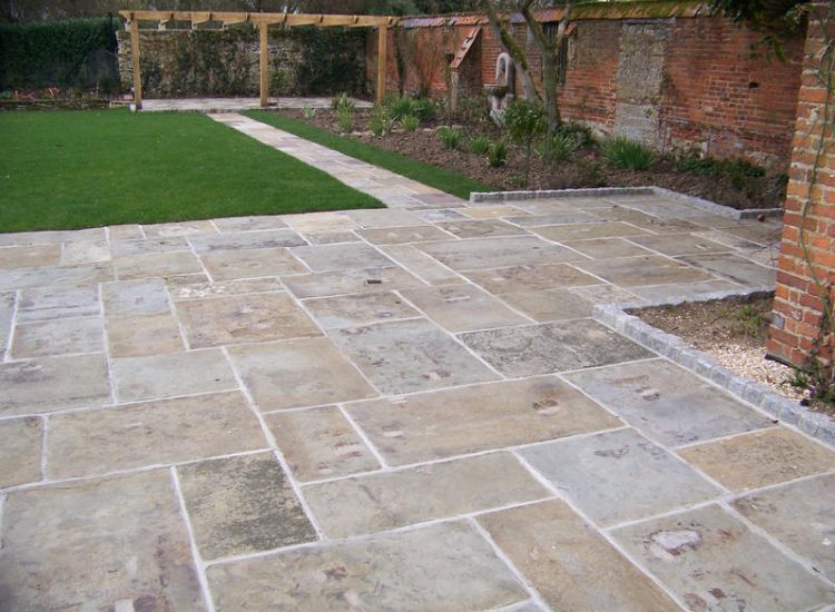 Reclaimed Yorkstone Paving in Dippenhall, Farnham, Surrey - A large rear terrace relaid using traditional reclaimed English Yorkstone. Garden Paving - MDB Landscapes