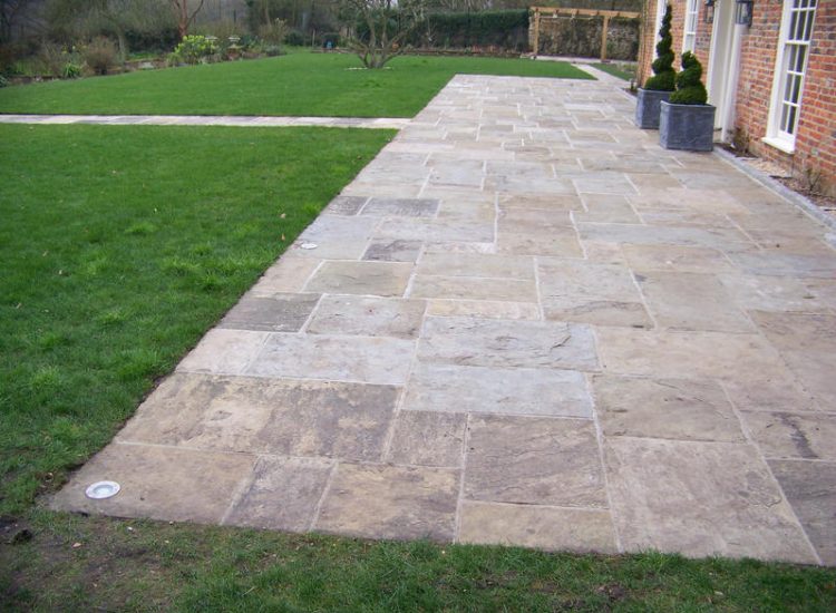 Reclaimed Yorkstone Paving in Dippenhall, Farnham, Surrey - A large rear terrace relaid using traditional reclaimed English Yorkstone. Garden Paving - MDB Landscapes