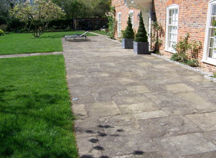 Reclaimed Yorkstone Paving in Dippenhall, Farnham, Surrey - A large rear terrace relaid using traditional reclaimed English Yorkstone. Garden Paving - MDB Landscapes