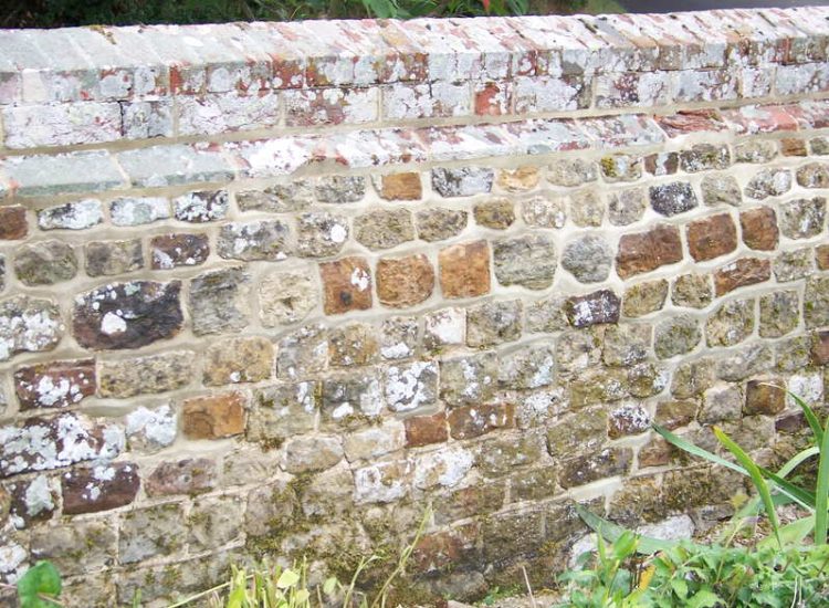 Repointing works in West Lavington, Midhurst, West Sussex - Repointing of an old dilapidated stone wall. Re-pointing works for Surrey and Hampshire - MDB Landscapes