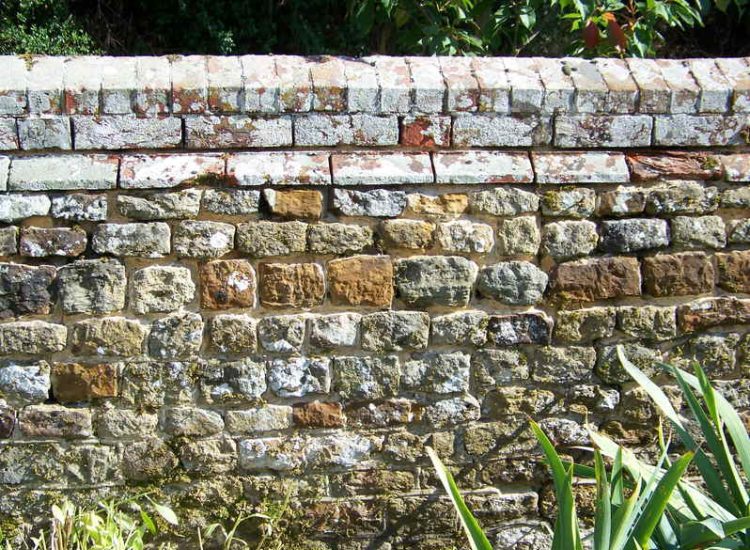 Repointing works in West Lavington, Midhurst, West Sussex - Repointing of an old dilapidated stone wall. Re-pointing works for Surrey and Hampshire - MDB Landscapes