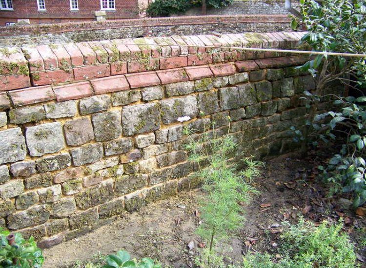 Repointing works in West Lavington, Midhurst, West Sussex - Repointing of an old dilapidated stone wall. Re-pointing works for Surrey and Hampshire - MDB Landscapes