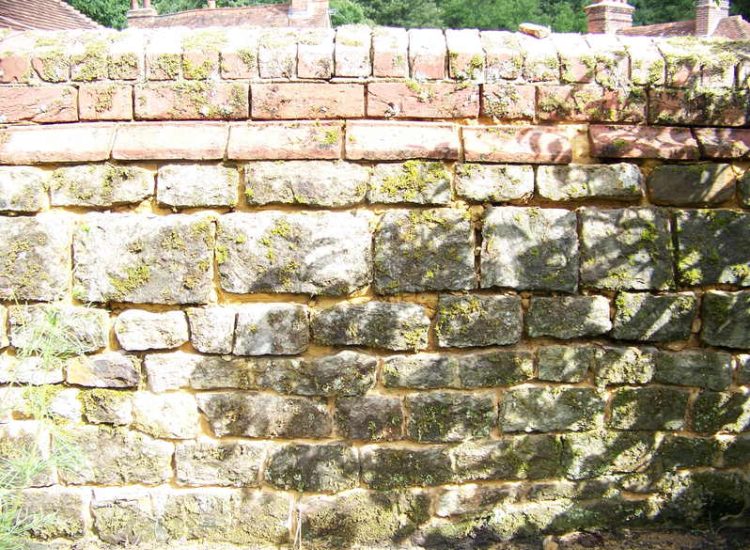 Repointing works in West Lavington, Midhurst, West Sussex - Repointing of an old dilapidated stone wall. Re-pointing works for Surrey and Hampshire - MDB Landscapes