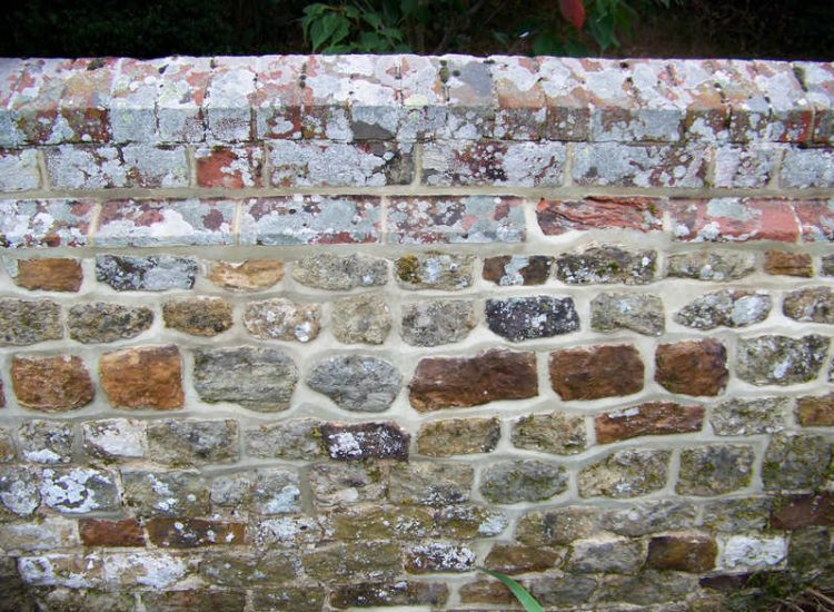 Repointing works in West Lavington, Midhurst, West Sussex - Repointing of an old dilapidated stone wall. Re-pointing works for Surrey and Hampshire - MDB Landscapes