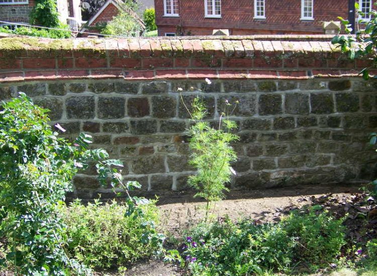 Repointing works in West Lavington, Midhurst, West Sussex - Repointing of an old dilapidated stone wall. Re-pointing works for Surrey and Hampshire - MDB Landscapes