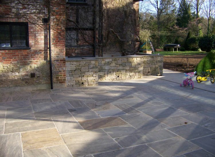 New Yorkstone Paving in Bramley, Surrey - Six sided sawn new Yorkstone paving was used here through out the rear and front gardens. Garden Paving - MDB Landscapes