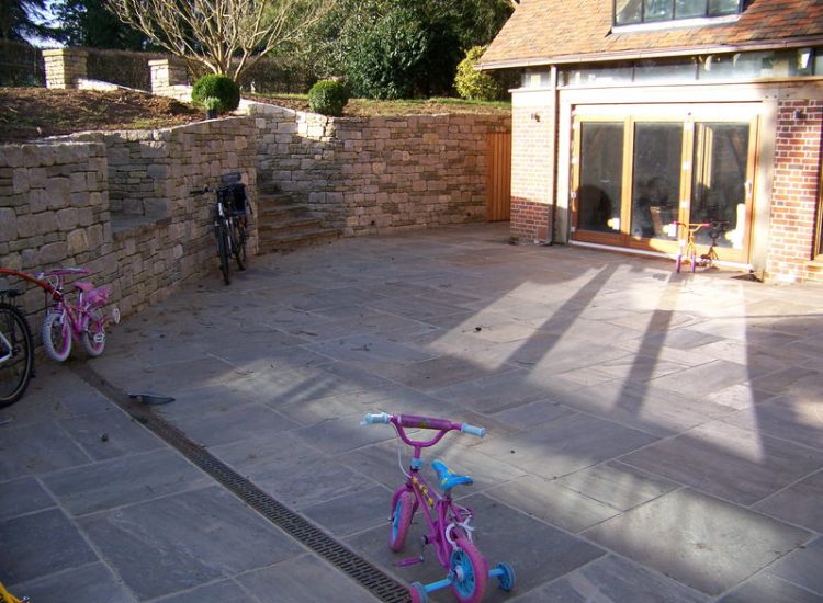 New Yorkstone Paving in Bramley, Surrey - Six sided sawn new Yorkstone paving was used here through out the rear and front gardens. Garden Paving - MDB Landscapes
