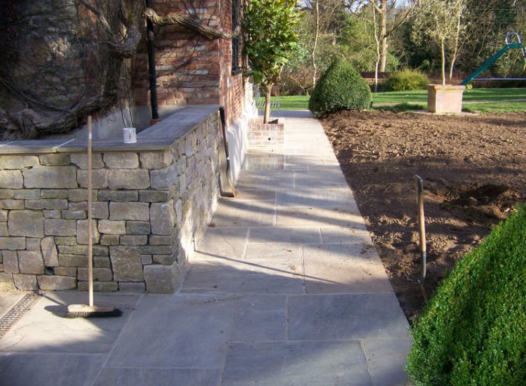 New Yorkstone Paving in Bramley, Surrey - Six sided sawn new Yorkstone paving was used here through out the rear and front gardens. Garden Paving - MDB Landscapes