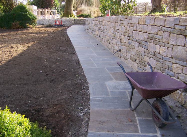 New Yorkstone Paving in Bramley, Surrey - Six sided sawn new Yorkstone paving was used here through out the rear and front gardens. Garden Paving - MDB Landscapes