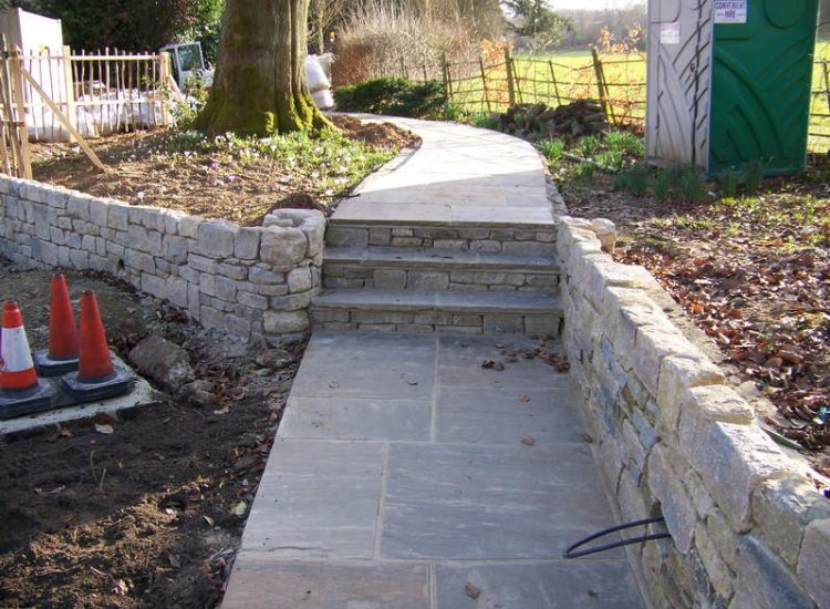 New Yorkstone Paving in Bramley, Surrey - Six sided sawn new Yorkstone paving was used here through out the rear and front gardens. Garden Paving - MDB Landscapes