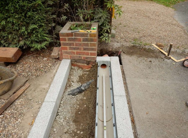 Driveway Drainage Esher, Surrey - As part of further drainage works within the rear garden of this property surface water linear drainage was installed along the entrance of the property within a new granite set cross over area. Garden drainage - MDB Landscapes