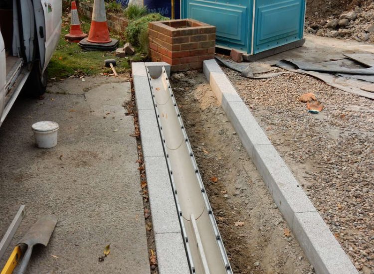 Driveway Drainage Esher, Surrey - As part of further drainage works within the rear garden of this property surface water linear drainage was installed along the entrance of the property within a new granite set cross over area. Garden drainage - MDB Landscapes