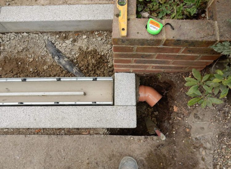 Driveway Drainage Esher, Surrey - As part of further drainage works within the rear garden of this property surface water linear drainage was installed along the entrance of the property within a new granite set cross over area. Garden drainage - MDB Landscapes