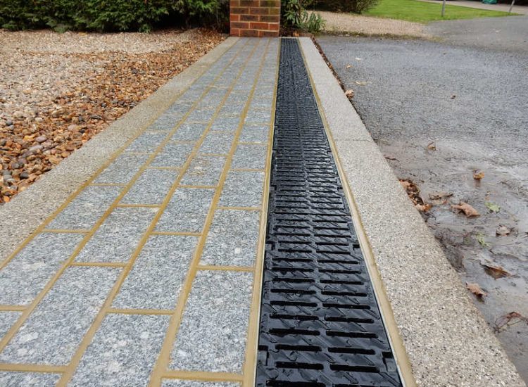 Driveway Drainage Esher, Surrey - As part of further drainage works within the rear garden of this property surface water linear drainage was installed along the entrance of the property within a new granite set cross over area. Garden drainage - MDB Landscapes