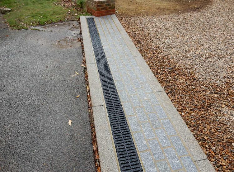Driveway Drainage Esher, Surrey - As part of further drainage works within the rear garden of this property surface water linear drainage was installed along the entrance of the property within a new granite set cross over area. Garden drainage - MDB Landscapes