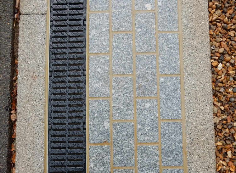 Driveway Drainage Esher, Surrey - As part of further drainage works within the rear garden of this property surface water linear drainage was installed along the entrance of the property within a new granite set cross over area. Garden drainage - MDB Landscapes