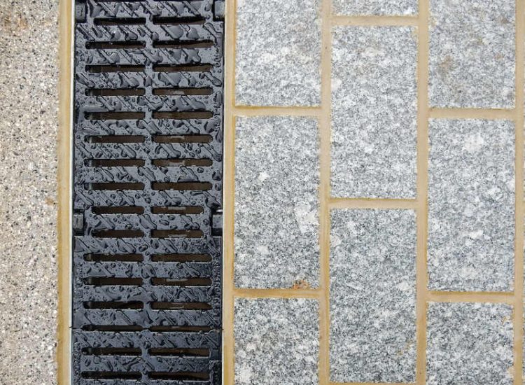 Driveway Drainage Esher, Surrey - As part of further drainage works within the rear garden of this property surface water linear drainage was installed along the entrance of the property within a new granite set cross over area. Garden drainage - MDB Landscapes