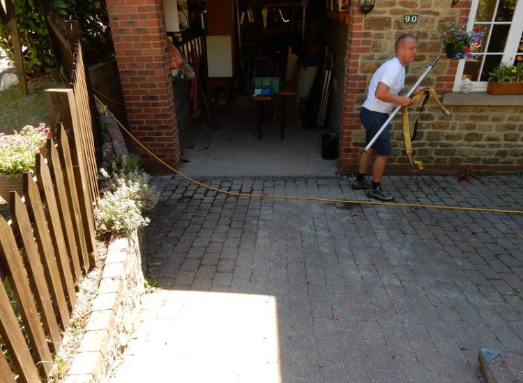 Driveway Drainage Farnham, Surrey - To help prevent further flooding of their garage the existing poor drainage infront of the garage was replaced with wide cast iron grated linear drainage channels. Garden Drainage - MDB Landscapes