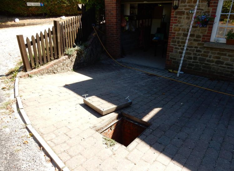Driveway Drainage Farnham, Surrey - To help prevent further flooding of their garage the existing poor drainage infront of the garage was replaced with wide cast iron grated linear drainage channels. Garden Drainage - MDB Landscapes