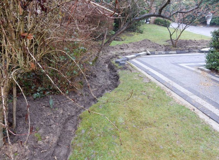 Driveway Drainage Ottershaw, Surrey - Linear drainage with cast iron gratings were proposed here to help prevent the constant threat of flooding from run off from the road. Water was diverted through large diamater pipe work and land drainage finaly being dispersed at the bottom of the garden. Garden Drainage - MDB Landscapes