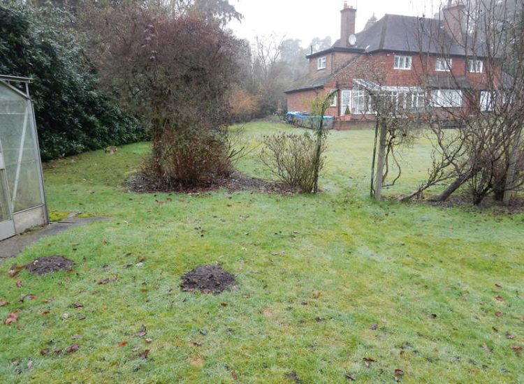 Driveway Drainage Ottershaw, Surrey - Linear drainage with cast iron gratings were proposed here to help prevent the constant threat of flooding from run off from the road. Water was diverted through large diamater pipe work and land drainage finaly being dispersed at the bottom of the garden. Garden Drainage - MDB Landscapes